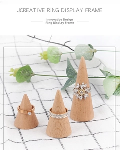 Three-piece solid wood cone ring stands in small, medium, and large sizes on white fabric