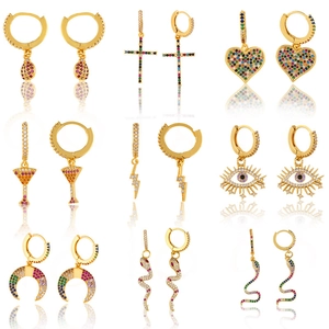 Macro view of gold hoop earrings set with colorful zircon stones in various charm shapes