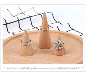 Detailed view of natural wooden cone ring display stand with circular tray and rings