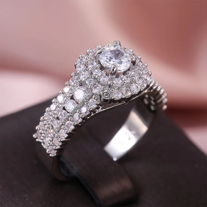 Macro detail of S925 silver ring with a brilliant round diamond and full pavé setting