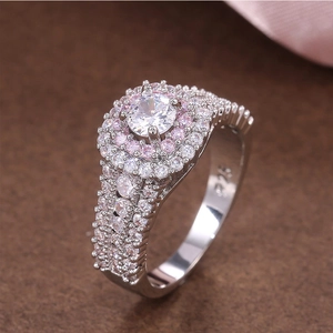 Macro detail of S925 silver ring featuring round white stone with double pink halo