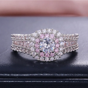 Macro shot of princess cut halo ring with pink accents and pavé diamond band