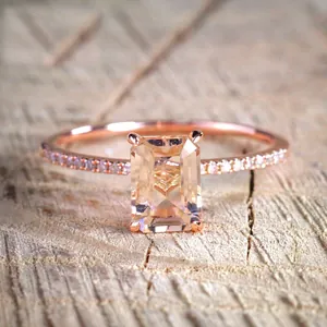 Elegant 18K rose gold engagement ring set with emerald cut yellow stone and pavé diamonds
