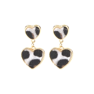 Detailed view of layered heart-shaped drop earrings with cow print and gold alloy borders