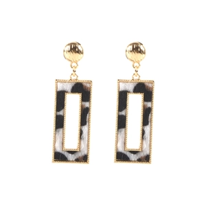 Close-up of geometric rectangle earrings with leopard print texture and gold studs