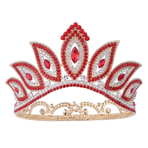 Detailed shot of golden baroque bridal crown with luxury red and white rhinestones