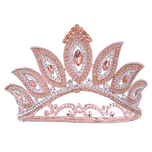 Detailed close-up of a rose gold bridal crown featuring amber and clear rhinestones