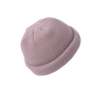 Close-up of pink knitted miki hat showing fine ribbed texture and folded brim detail