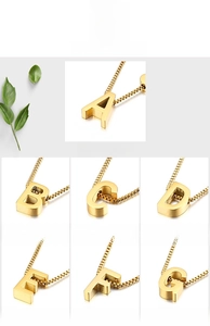 Detail view of gold titanium steel heart alphabet pendants on classic box chains