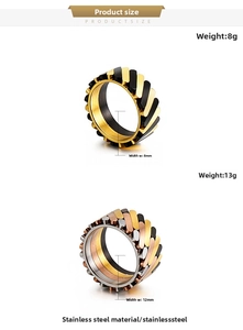 Detail of mechanical rotating chain rings in gold, black, and silver stainless steel