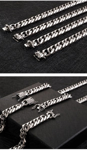 Detail of silver titanium steel men's bracelets with square buckles on textured box