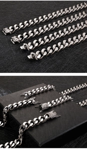 Detailed macro view of silver stainless steel Cuban links with diamond-set box clasps