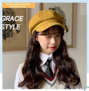 Ginger yellow suede newsboy hat shown in a stylish studio setting on a model