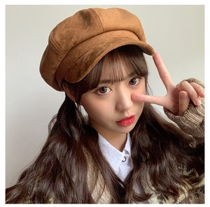 Detailed view of a brown suede newsboy cap featuring retro British style and soft texture