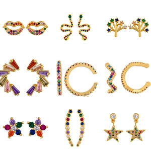 Set of 9 gold geometric stud earrings with colorful cubic zirconia in heart and snake shapes