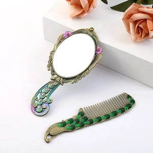 Vintage peacock hand mirror and comb set in bronze metal with colorful enamel inlay