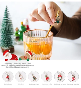 Detailed view of six gold Christmas spoons featuring Santa, Reindeer, and Tree charms