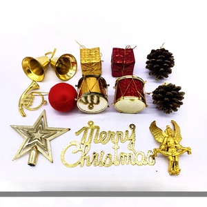 Assorted Christmas tree ornaments set with gold bells, red gift boxes, and pine cones