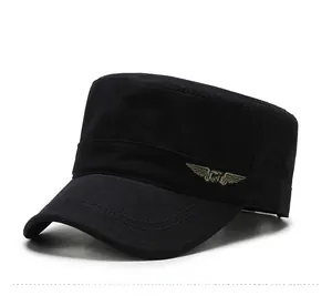 Detail of embroidered gold star and wing badge on black cotton flat top military cap