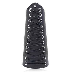 Close-up of black leather punk wristband with metal eyelets and adjustable lacing
