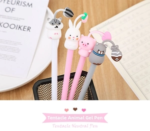 Detail of four cartoon animal neutral pens with soft tentacles in a desk pen holder