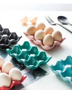 Detailed view of colorful 6-slot ceramic egg trays in pink, red, blue, and green finishes