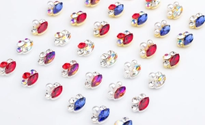 Macro detail of marquise gems and pearls with metal edging for nail art decoration