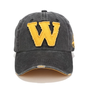 Detailed view of gray washed cotton baseball cap with yellow W patch and distressed frayed edges