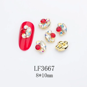 Close-up of 8x10mm marquise nail charm with red and clear rhinestones in gold setting