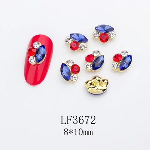 Macro detail of mixed color marquise rhinestones nail charm with gold metal base
