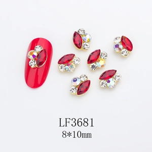 Macro view of 8x10mm red horse-eye nail gem with gold setting and rhinestones