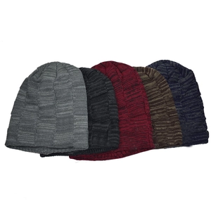 Close-up of knit winter beanies showing checkered texture in multiple colors