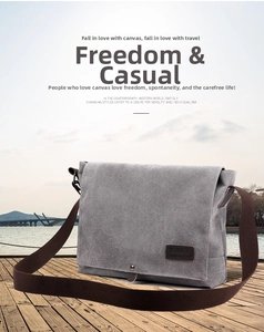 Outdoor close-up of grey canvas messenger bag with brown leather tag on wooden dock