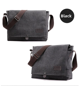 Detail of dark gray canvas messenger bag with brown strap and magnetic snap closure