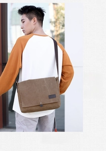 Brown canvas messenger bag for men shown on shoulder with minimalist KVKY logo detail