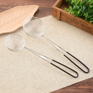 Set of two stainless steel skimmers with black silicone handles on a wooden table