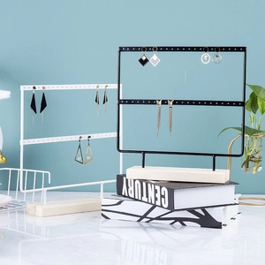 Dual iron jewelry organizer rack in black and white with wooden base for earrings