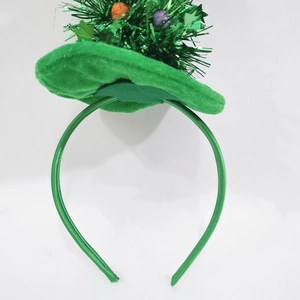 Detail of green Christmas tree headband with velvet texture, tinsel, and colorful mini balls