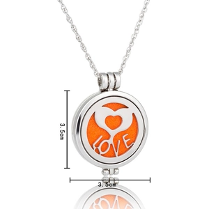 Detail of silver hollowed aromatherapy necklace with heart love design and 3.5cm diameter