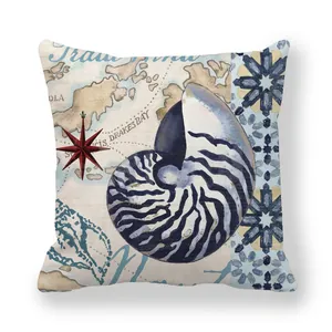 Macro detail of nautical vintage throw pillow featuring nautilus shell and sea map