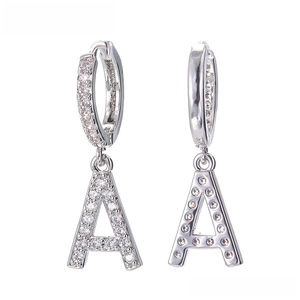 Detailed view of silver hoop earrings with pave cubic zirconia and letter A pendants