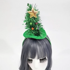 Detail of Christmas tree headband with golden star and colorful balls worn by a model