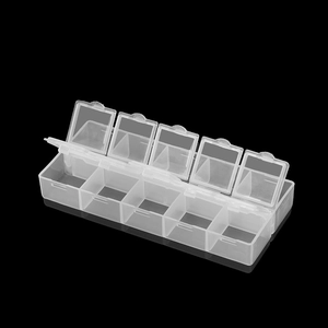 Macro view of transparent 10-compartment plastic storage box with independent lids for beads