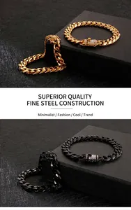 Close-up of gold and black stainless steel Cuban bracelets with diamond lion clasps