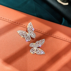 Elegant butterfly stud earrings with zircon inlay and silver pin on a dual-tone backdrop