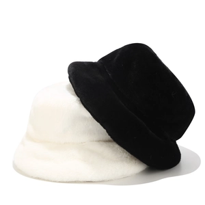 Detail of plush faux fur bucket hats in black and white colors with thick warm texture