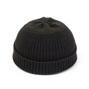 Detail of dark olive green knit docker hat showing thick ribbed texture and folded brim
