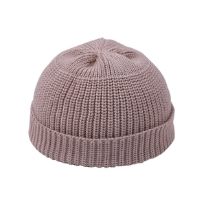 Detail of pink ribbed knit beanie showing thick texture and folded cuff for winter warmth