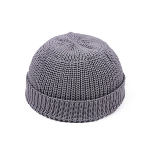 Detail of dark grey docker cap showing fine ribbed knit texture and folded brim edge