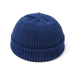 Detail of dark blue ribbed knit Miki hat featuring a retro rolled edge and textured fabric